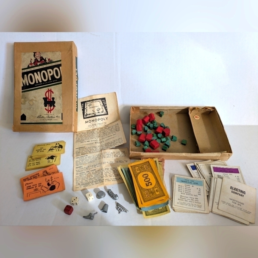 Vintage Monopoly game (1954) with wooden pieces.